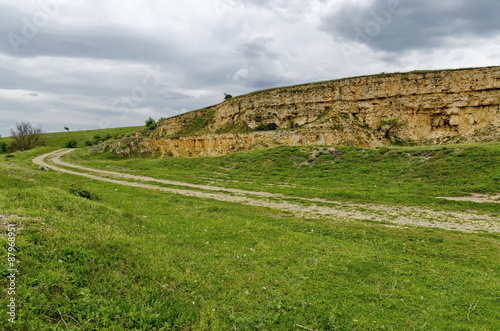 General view toward crag of sedimentary rock in the field  Ludogorie  Bulgaria  