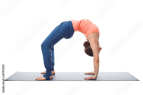 Beautiful sporty fit yogi girl practices yoga asana chakrasana photo