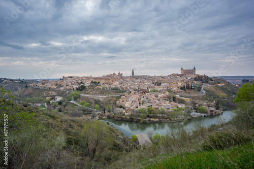 Wide angle view of Toledo with cloudy sky at sunset
