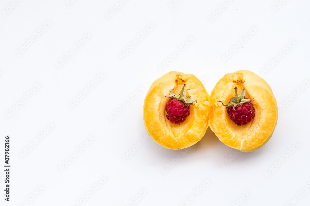 two raspberries in part apricot, copy space
