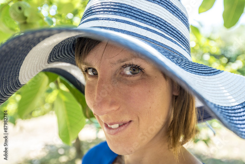 Pretty friendly woman in a stylish hat photo