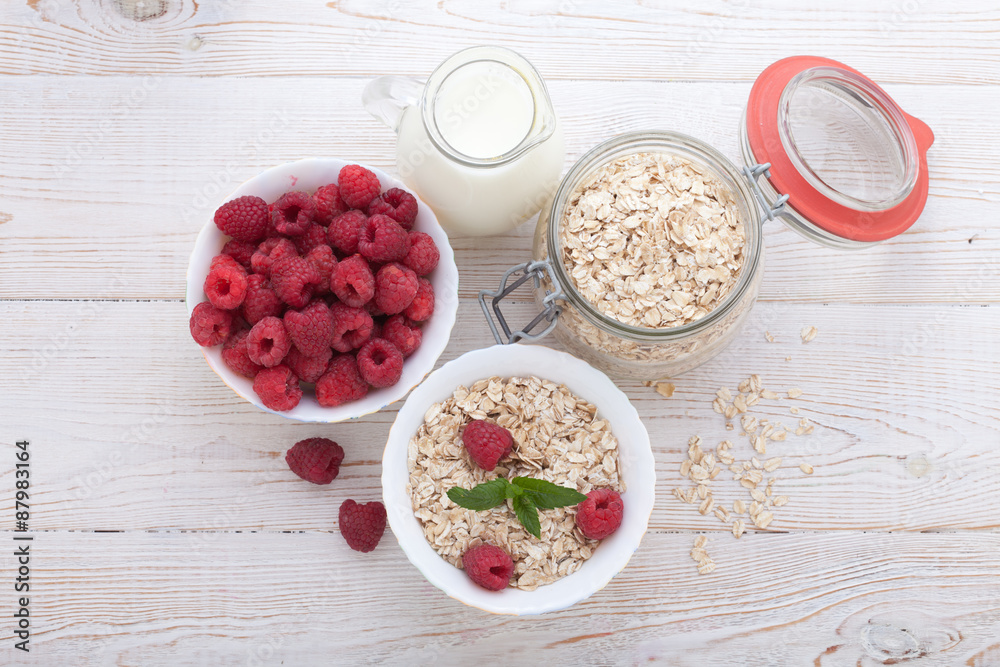 Berries, fruit, milk and muesli Ingredients for healthy breakfast on wooden table Berries, fruit, milk and muesli Ingredients for healthy breakfast on wooden table