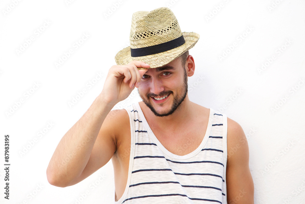 Happy young man posing against white background with hat Happy young man posing against white background with hat