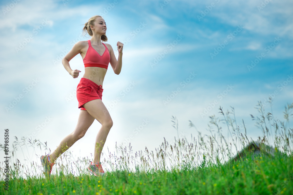 Young woman running summer park rural road. Outdoor exercises. J Young woman running summer park rural road. Outdoor exercises. J