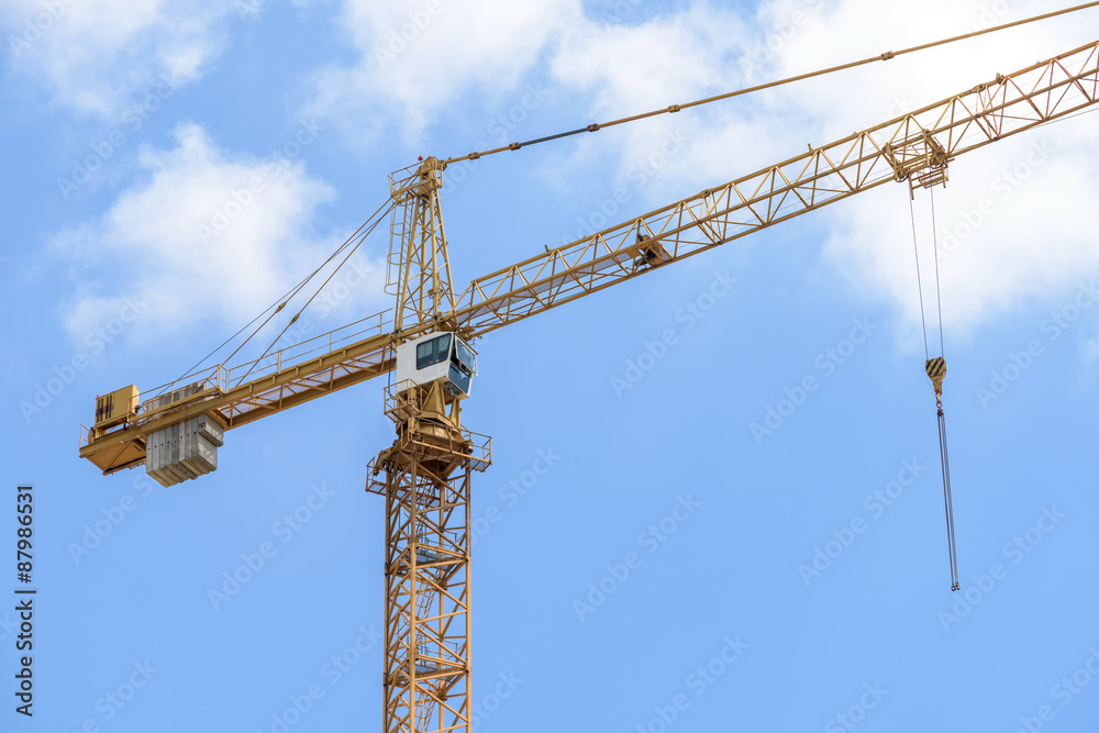 Industrial Construction Crane Against Blue Sky With Clouds