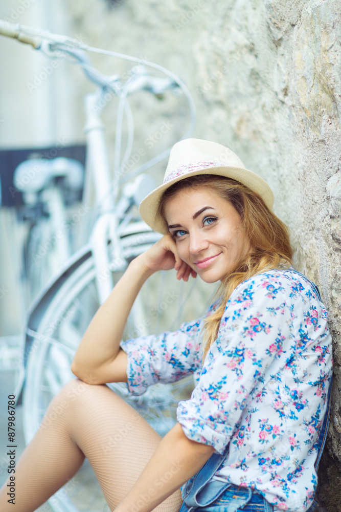 Beautiful woman with bicycle on street of old town