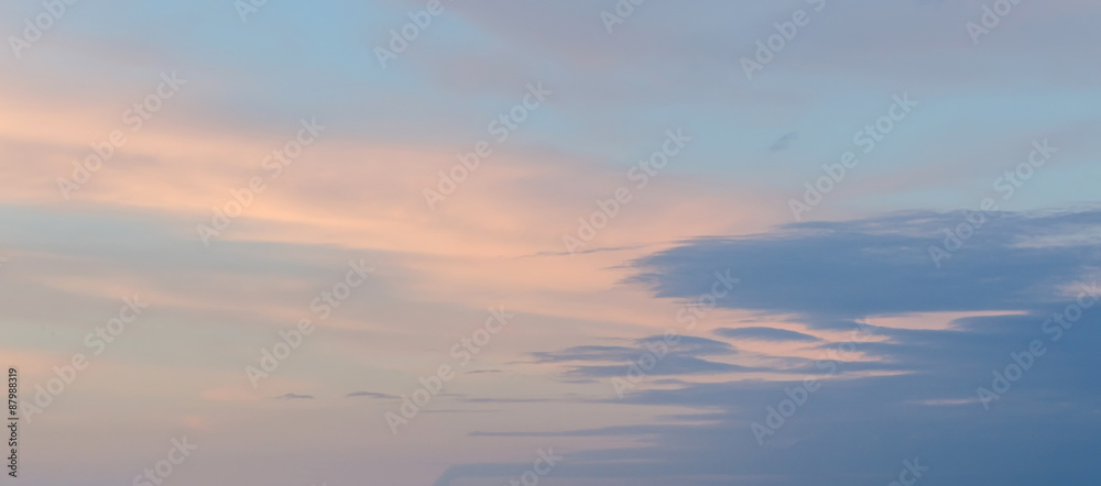 Blue sky with fluffy colored clouds, ray of lights, sunset, dawn.