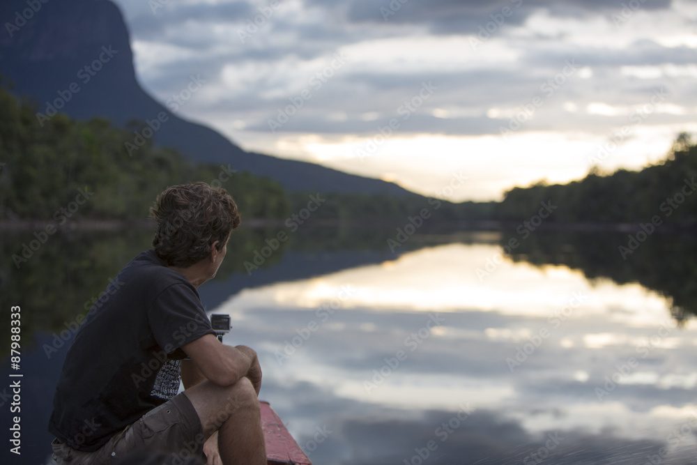 Man looking the sunset on the Auyantepui mountain in the Canaima