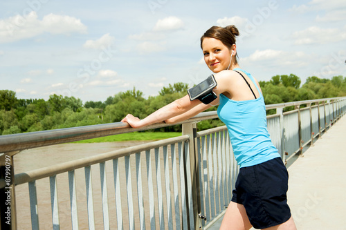 Young tired woman rest after run in the city over the bridge. © Wisiel