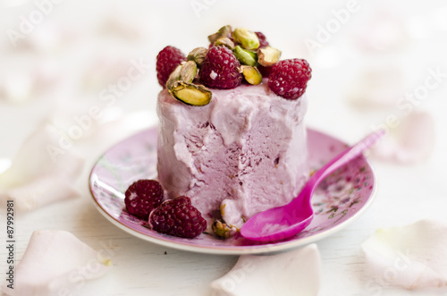 Raspberry ice cream with raspberry and pistachios 