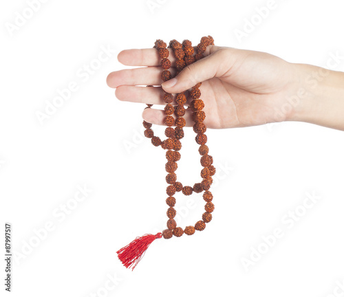 Rudraksha rosary in a female hand. Japa mala
