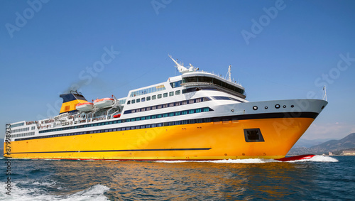 Billede på lærred Big yellow passenger ferry goes on the Sea