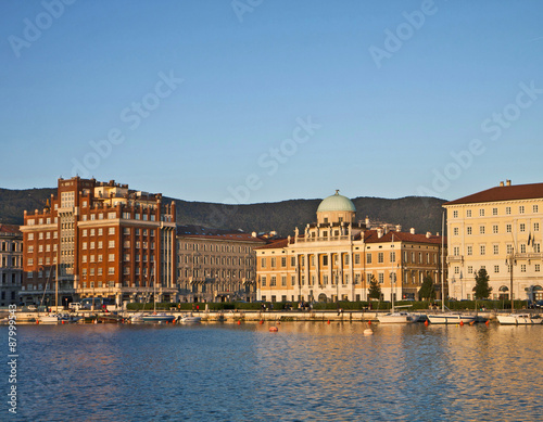 Trieste, Italy, Rive at sunset with neo-classical Carciotti palace, former headquarter of Generali insurance photo