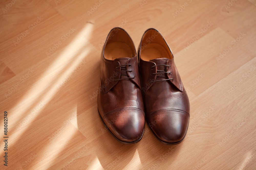 Brown men's shoes. Sunlight.