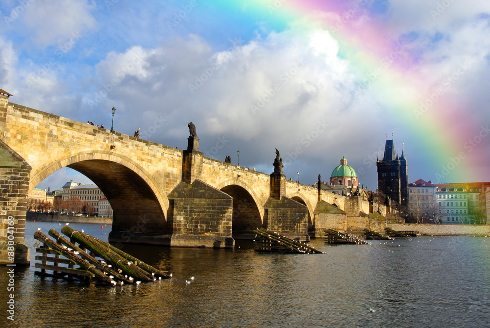 Rainbow in the sky above Charles' Bridge in Prague, Czech Republic, on a sunny day, just after rain. Cityscape with dramatic sky.