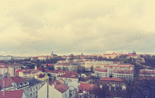 Panoramic view on Prague, Czech Republic, from the top of Vysehrad fortress on a cloudy day. Image filtered in faded, washed out, retro style; nostalgic travel vintage concept.