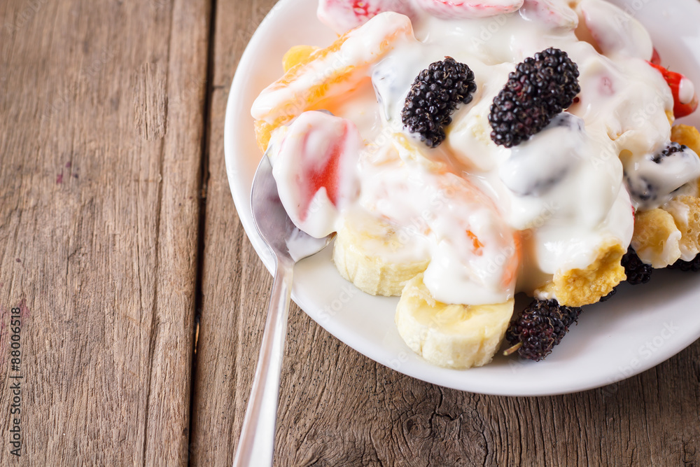 fruit salad with cream, banana, strawberry, orange, mulberry. fruit salad with cream, banana, strawberry, orange, mulberry.