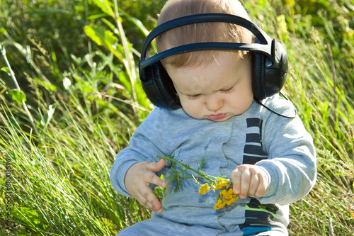 Child considers the branch of tansy photo