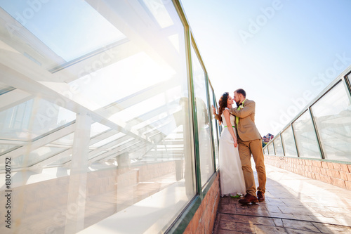 Bride and groom kissing on sunset