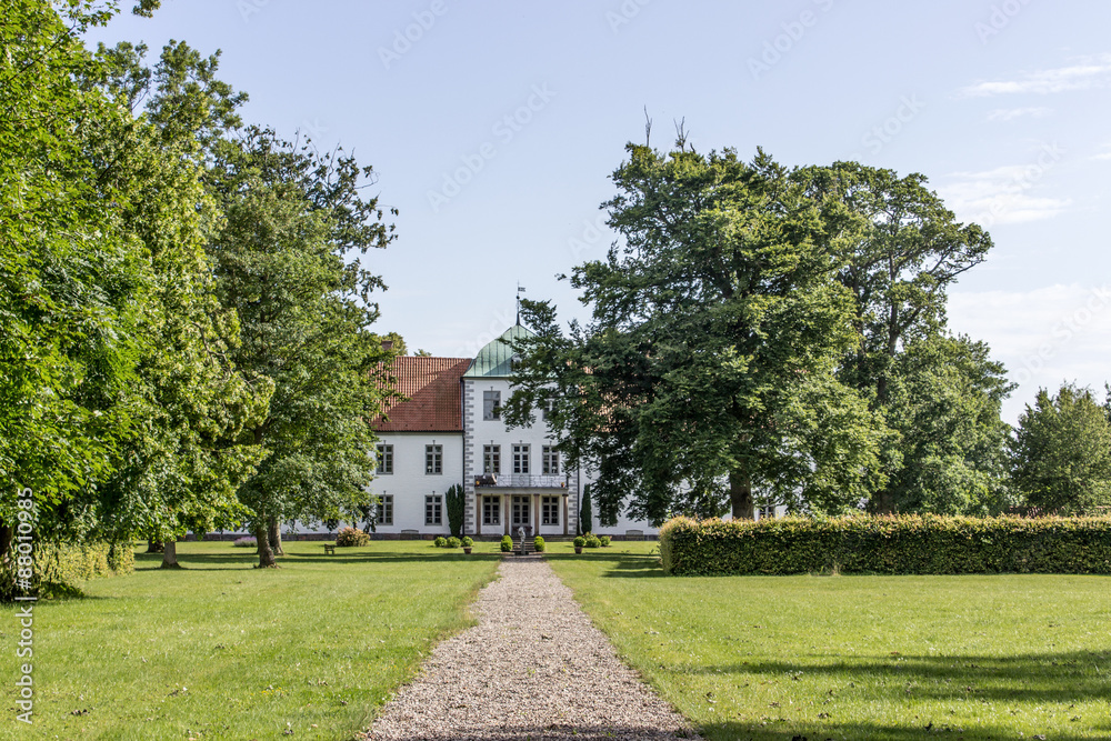 Manor / Manor and park with lawns, trees, blue sky and clouds