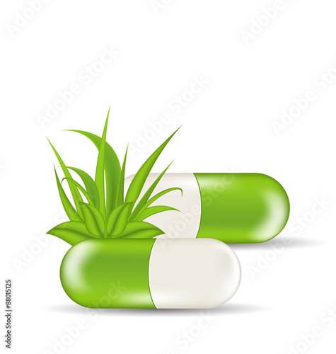 Natural medical pills with green leaves and grass, isolated on w