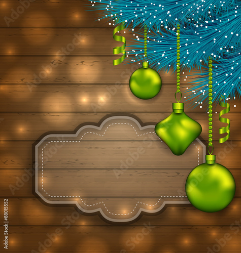 New Year label with balls and fir twigs on wooden texture with l
