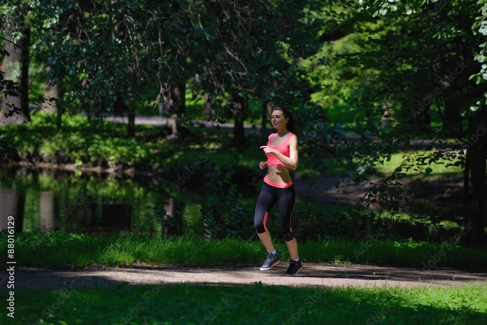 Beautiful woman runner running in city park Beautiful woman runner running in city park
