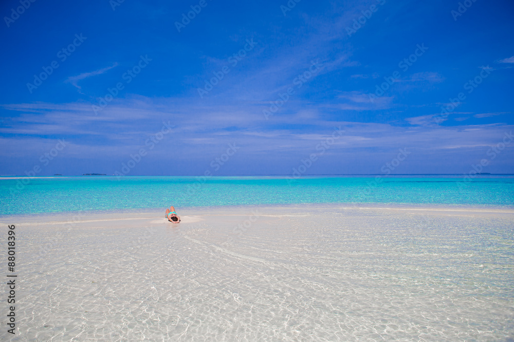 Young beautiful woman at shallow tropical water