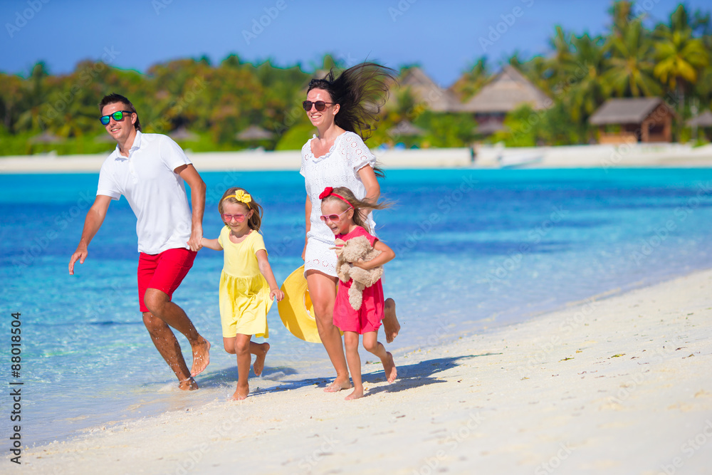 Young happy family with two kids on summer vacation