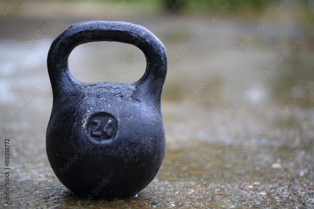 Fototapeta premium Black 24 The kilogram weight on the pavement