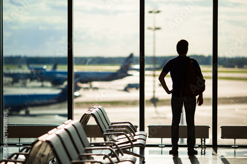 Silhouette of a man waiting to board a flight in airport