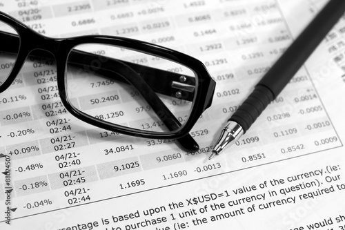 Glasses  financial documents and  pencil