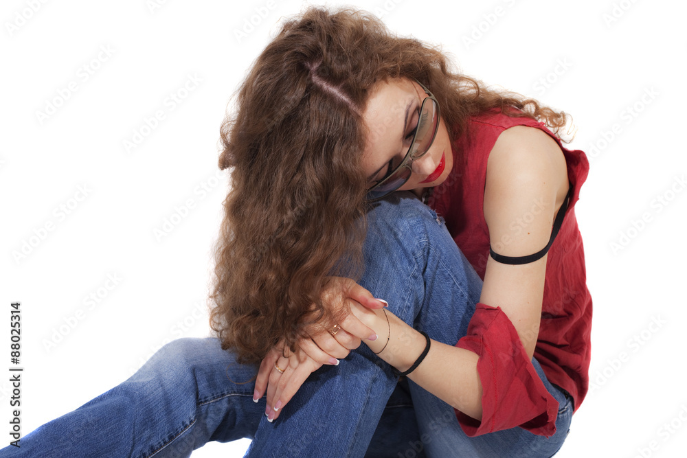 beautiful curly brunette woman in red T-shirt and blue jeans on beautiful curly brunette woman in red T-shirt and blue jeans on