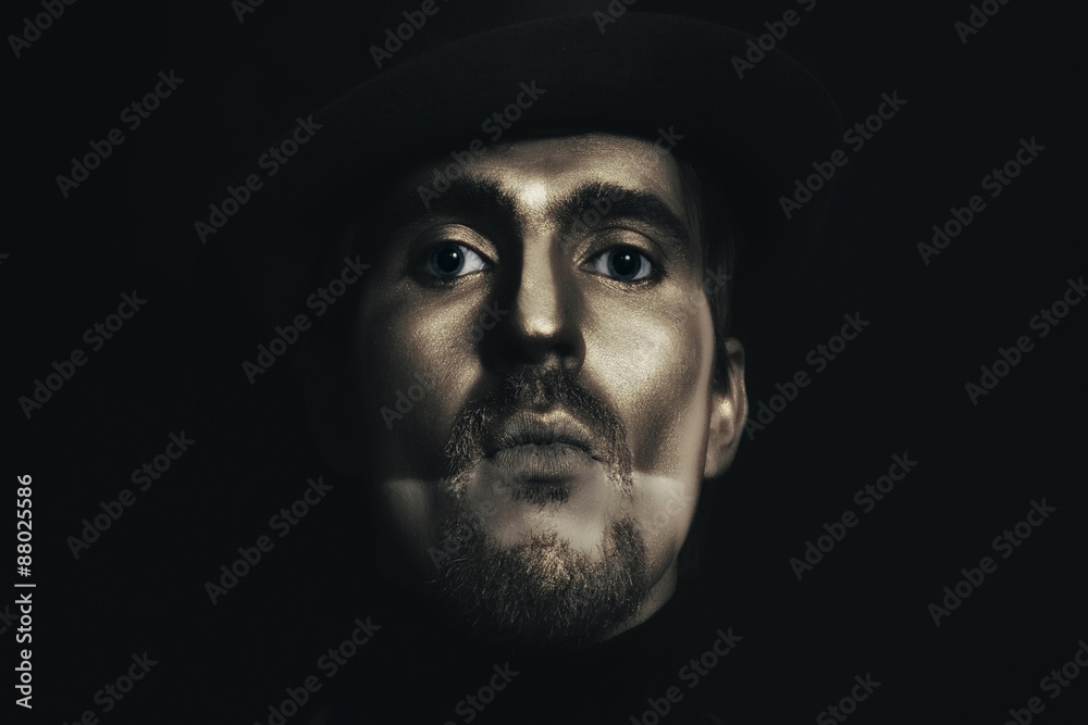 man in hat with bronze makeup man in hat with bronze makeup