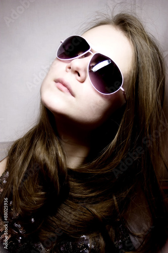 Portrait of the young woman in sunglasses