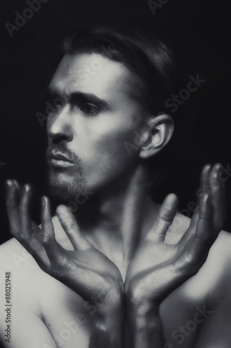 monochrome portrait of young attractive man with a silvery makeu