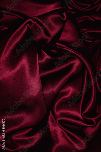 Texture of  burgundy satin close up photo