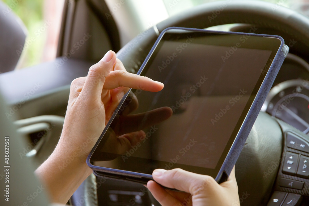Woman Sitting in the Car and Using digital tablet