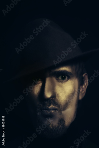 man in hat with bronze makeup © korionov
