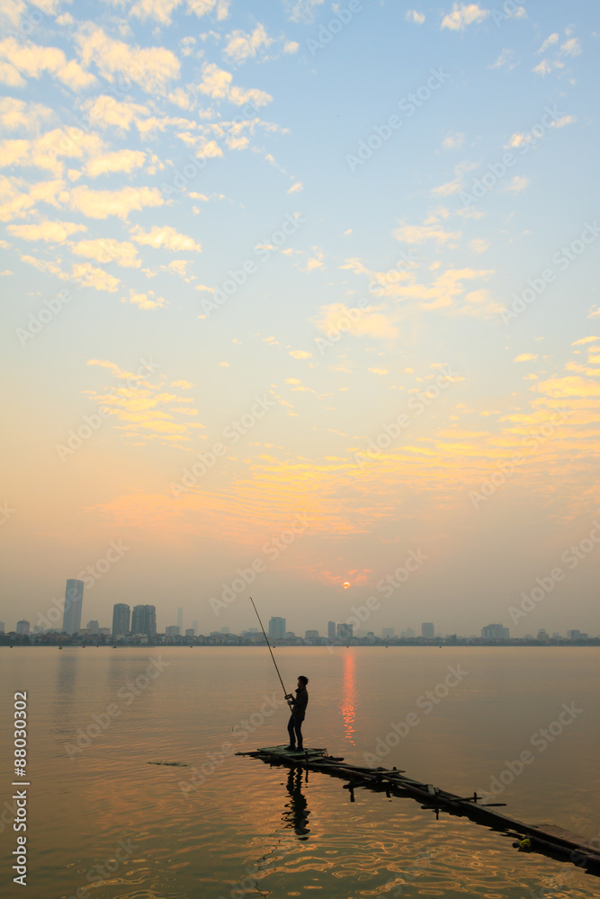 Fisher man on the west lake, hanoi, vietnam