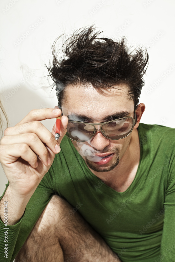 Obraz premium young guy with a cigarette in sunglasses