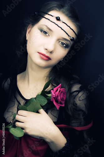 young woman with a rose. medieval style photo