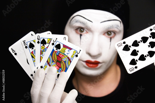 mime with playing cards on black background