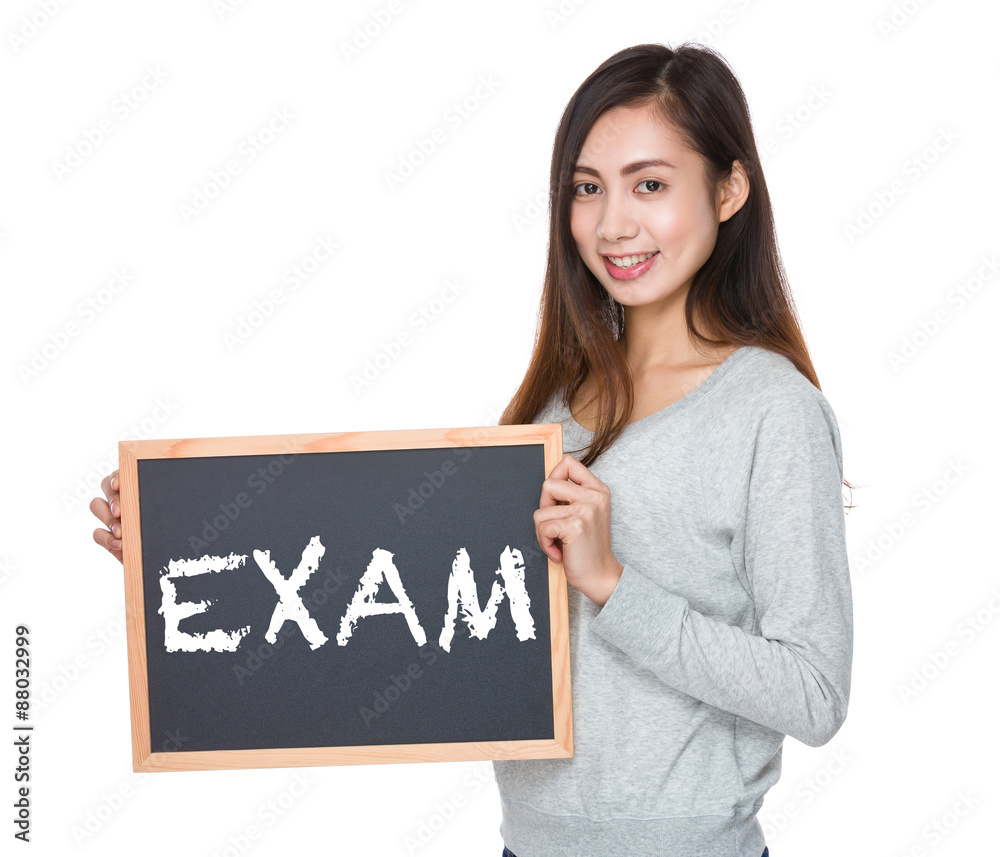 Pretty woman hold with blackboard and showing a word exam Pretty woman hold with blackboard and showing a word exam
