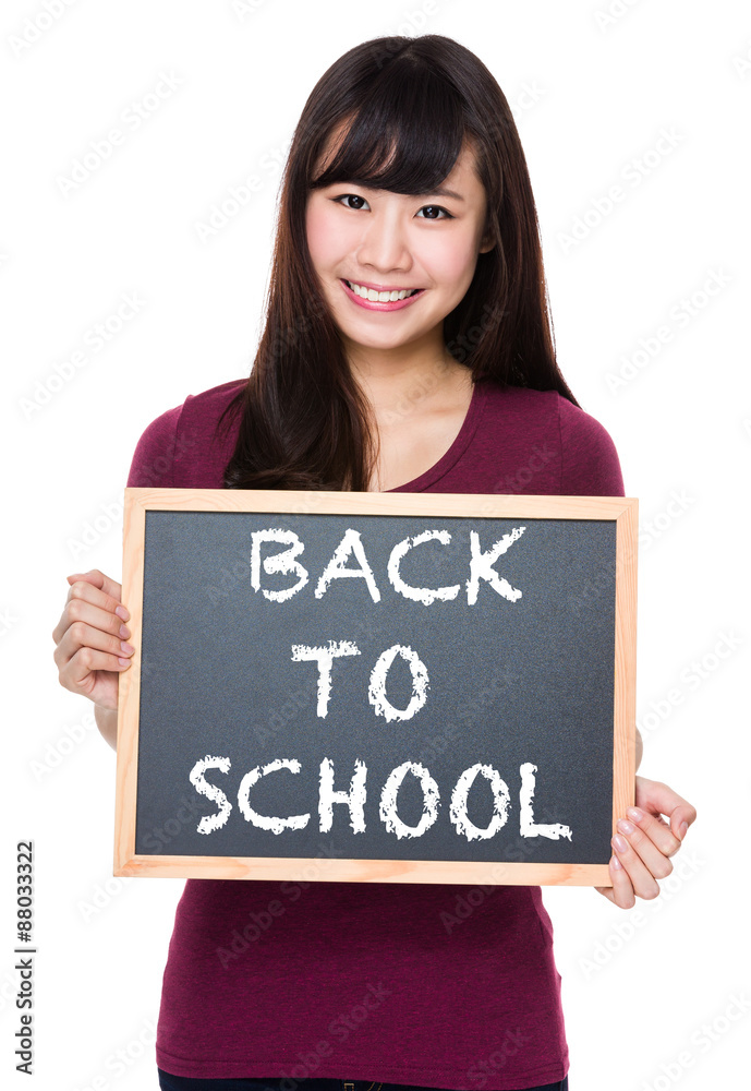 Woman with black board and showing phrase of back to school Woman with black board and showing phrase of back to school
