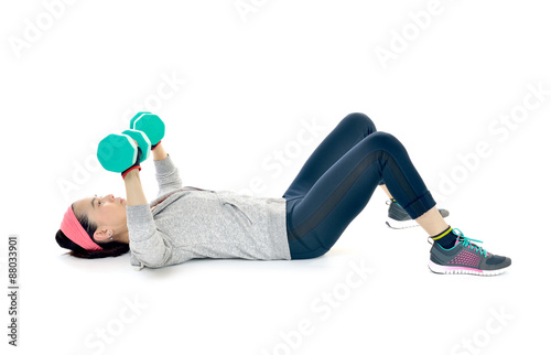 Middle aged woman exercising with dumbbells isolated on white background