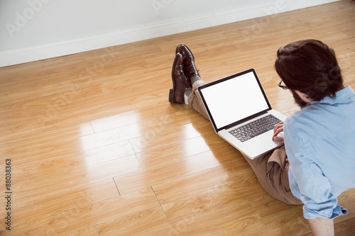 Handsome hipster using his laptop