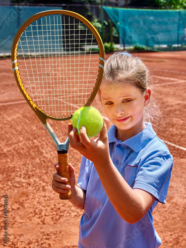 Sister girl athlete  with racket and ball photo