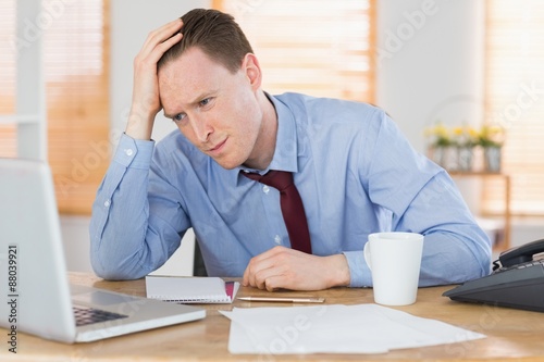 Stressed businessman working at his desk