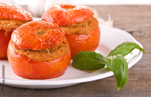 Stuffed tomatoes on a white plate. 